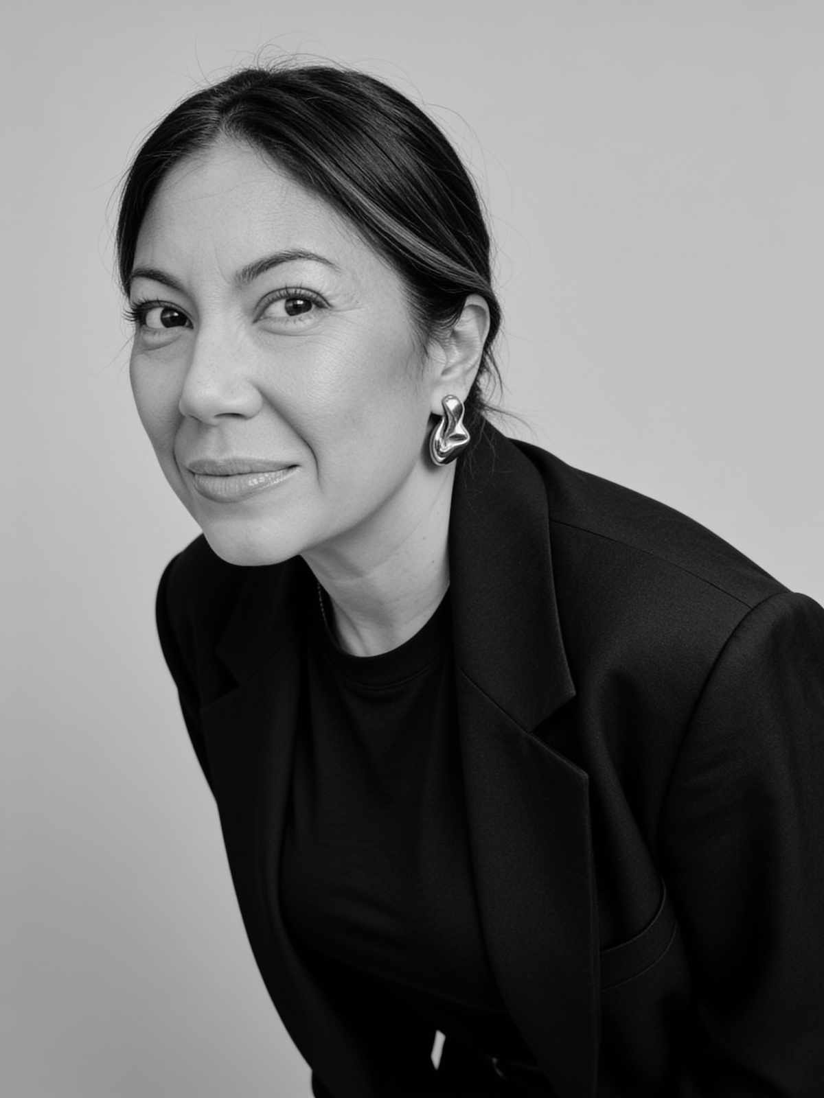 Creator Maresa Friedman in a black blazer, photographed in a monochrome studio portrait.